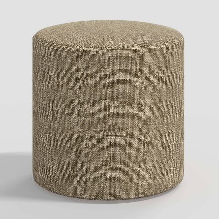 a small round ottoman with a light brown textured upholstered fabric on the top