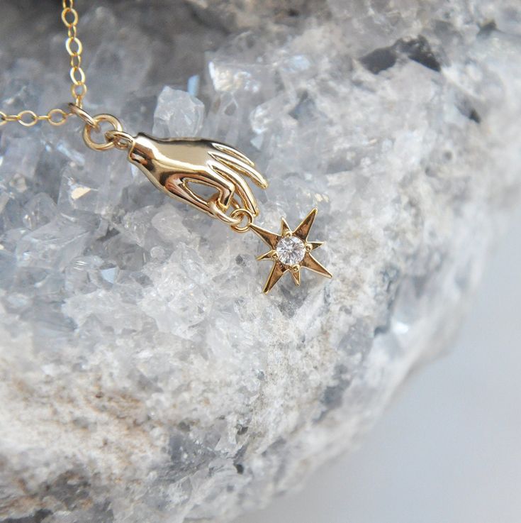 "Catch a Falling Star Necklace // Palmistry Necklace // Gold Hand Necklace // Silver Hand Necklace // North Star Pendant This shiny silver or gold hand is holding a dainty north star featuring a cubic zirconia stone in the center. Suspended from a delicate 14k gold filled chain or 925 sterling silver chain necklace at the length of your choice. Whether searching for a unique gift for someone special or a little something just for you, all of my jewelry arrives suitably gift wrapped ready for gif Catch A Falling Star, Phoenix Necklace, North Star Necklace, Falling Star, Fire Opal Necklace, Moon And Star Earrings, Hand Necklace, Celestial Necklace, Gold Hand