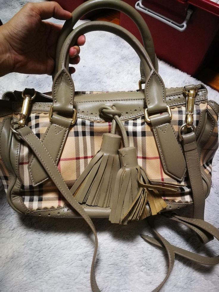 Authentic Burberry handbag Top handle and long strap very good condition  Dustbag included. Measurements Length: 13 inches Height: 7.5 inches Burberry Vintage Crossbody Bag, Designer Handheld Satchel With Adjustable Strap, Designer Handheld Satchel With Detachable Strap, Designer Satchel With Detachable Handle, Designer Beige Satchel With Branded Hardware, Handheld Satchel With Branded Hardware For Shopping, Designer Beige Handheld Satchel, Handheld Satchel For Shopping With Branded Hardware, Double Handle Shoulder Bag With Branded Hardware