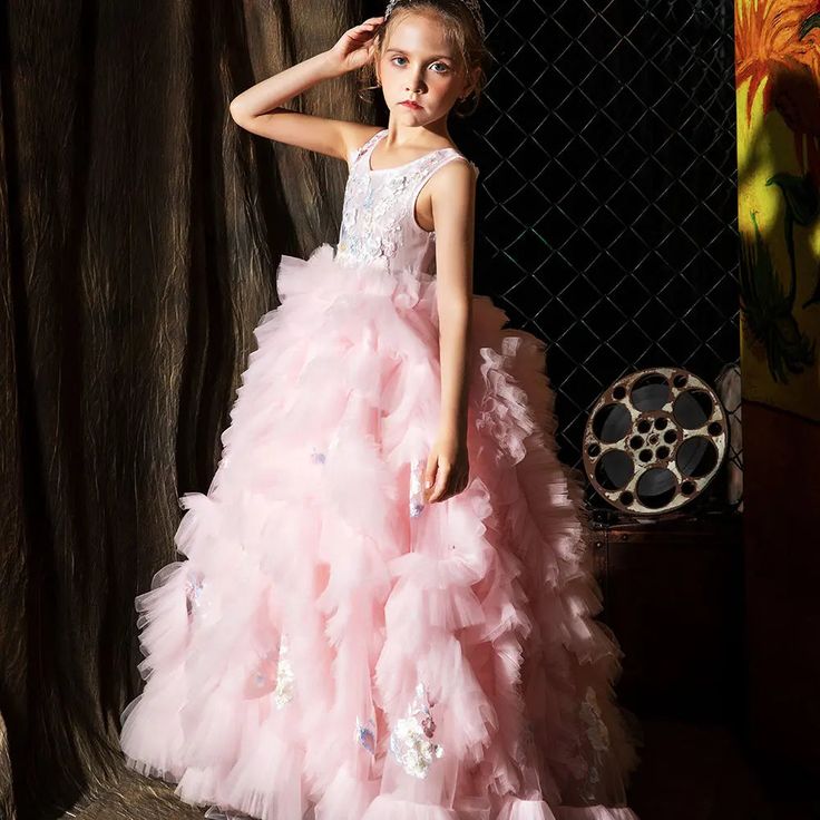 Indulge your little girl's royalty with our Dreamy Vow Pink Luxury Dubai Kids Girl Dress. This stunning ball gown features intricate Arabic appliques and tiered layers, perfect for weddings, parties, birthdays, or pageants. Give her the spotlight she deserves with this princess-worthy dress. Quinceanera Pageant Ball Gown With Ruffles, Ruffled Ball Gown Princess Dress For Quinceanera, Tulle Ball Gown Pageant Dress With Ruffles, Quinceanera Princess Dress With Ruffles, Quinceanera Tulle Pageant Dress With Ruffles, Ruffled Ball Gown For Debutante Ball Pageant, Ruffled Ball Gown For Debutante Ball, Tulle Ruffle Pageant Dress For Prom Season, Tulle Pageant Dress With Ruffles For Prom Season