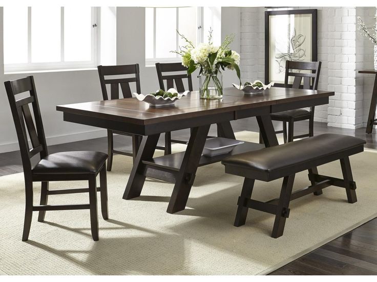 a dining room table and chairs in front of a window with white flowers on it