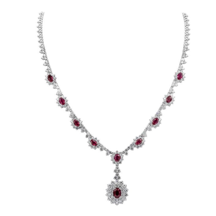 An elegant necklace, showcasing a drop pendant with a 1.30 carats oval cut ruby, surrounded by two rows of round brilliant cut diamonds. Accented by even more oval cut rubies surrounded by round brilliant cut diamond halos. Accent rubies weigh 4.63 carats total, and diamonds weigh 7.98 carats total. Finely made with 18K white gold. Roman Malakov is a custom house, specializing in creating anything you can imagine. If you would like to receive a special quote on a custom piece, please message or 1stdibs Jewelry, Diamond Drop Necklace, White Gold Pendant Necklace, Halo Necklace, Vintage Fine Jewelry, Chic Necklace, Drop Pendant Necklace, Halo Pendant, Ruby Necklace