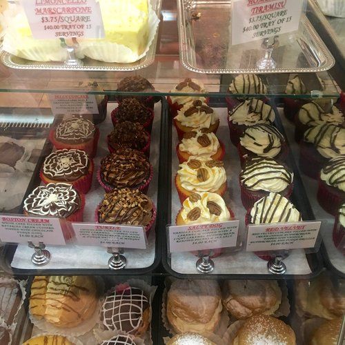 a display case filled with lots of different types of doughnuts and pastries