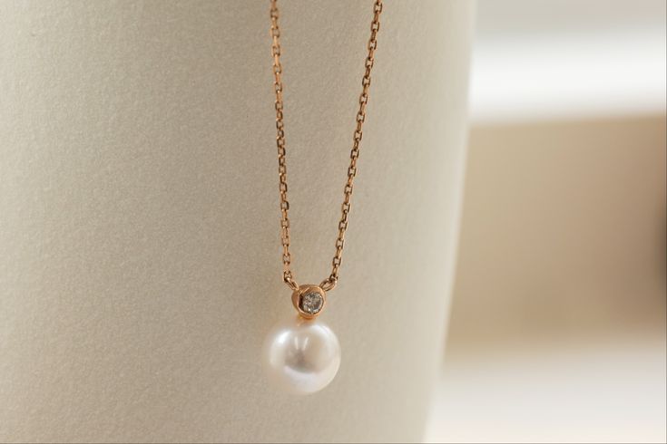 A combination of two birthstones for April (diamond) and June (pearl), the Saltwater Pearl & Diamond Necklace is a finishing piece for any classy occasion. Pairing suggestion:Saltwater Pearl & Diamond EarringsDimensions:Chain length: 40 cm, adjustable up to 42 cm (approx. 15.7 to 16.5 in) Materials used (pictured):14K solid rose gold, 1.44 g1 x saltwater pearl, 7 mm1 x champagne diamond, 0.1 ct Diamond Jewelry With Pearl Drop For Gift, Delicate Diamond Jewelry With Pearl Drop, Wedding Pearl Necklace With Gemstone, Timeless Pear-shaped Wedding Necklace, Pearl Briolette Jewelry For Anniversary, Fine Jewelry Pearl Necklace With Diamond Accents For Wedding, Fine Jewelry Wedding Pearl Necklace With Diamond Accents, Classic Pearl Necklace With Diamonds As A Gift, Classic Pearl Necklace With Diamond Accents For Wedding