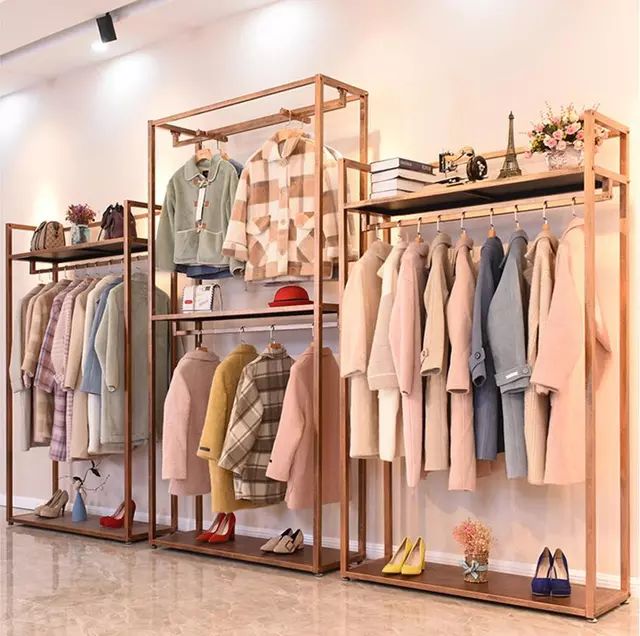 a clothing rack with clothes and shoes on it