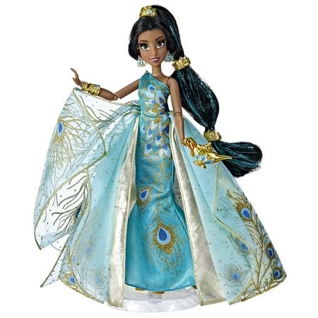 the doll is wearing a blue dress with gold trimmings and feathers on it