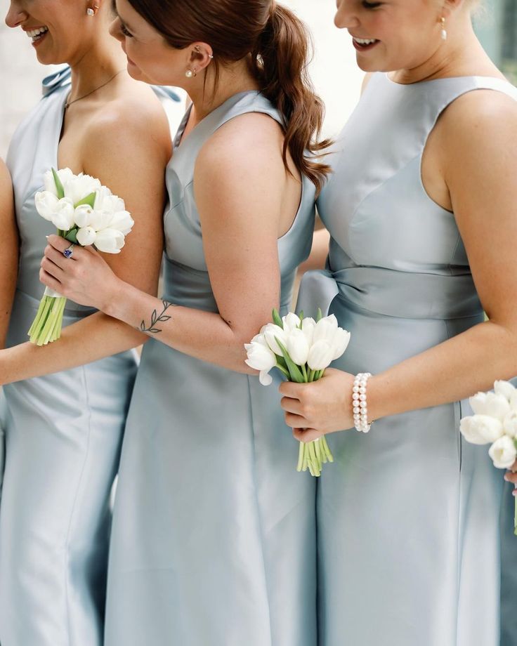 the bridesmaids are holding their bouquets together