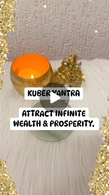 an orange candle sitting on top of a table next to a bowl filled with gold glitter