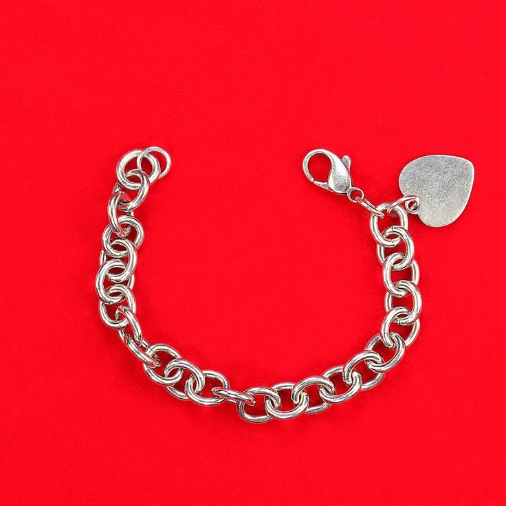 This is part of Chairish’s Costume Jewelry assortment.  Elegant Sterling Silver Link Bracelet with Heart – Perfect for Engraving  This sterling silver link bracelet with heart is a timeless piece that blends style with personalization. Crafted from high-quality sterling silver, this bracelet features open links with a charming heart charm, designed to be perfect for engraving a special message or initial. At 7.25 inches, it offers a versatile fit for most wrist sizes.  Weighing 29.4 grams, this Classic White Gold Charm Bracelet With Heart Charm, Classic White Gold Charm Bracelet With Heart, Everyday Silver Name Bracelet For Valentine's Day, Classic Silver Heart Bracelet, Everyday Silver Metal Heart Bracelet, Classic Heart-shaped Bracelets With Polished Finish, Silver Bracelets With Heart Charm For Everyday, Silver Bracelets With Heart Pendant For Everyday, Silver Bracelets With Heart Charm