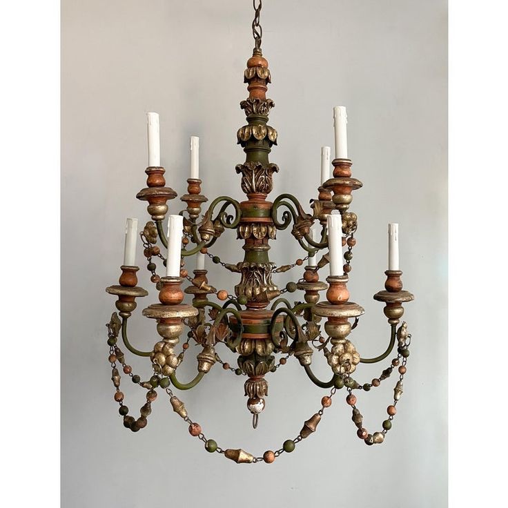 an old chandelier with candles hanging from it