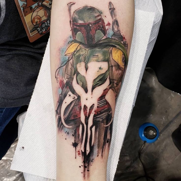 this is a tattoo with the boba fett helmet on it's arm