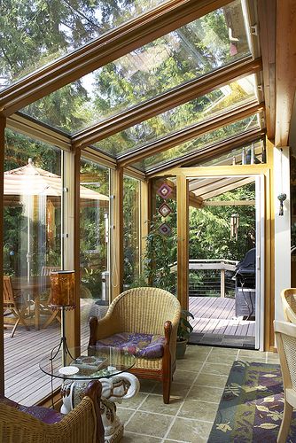 a sun room filled with furniture and lots of windows