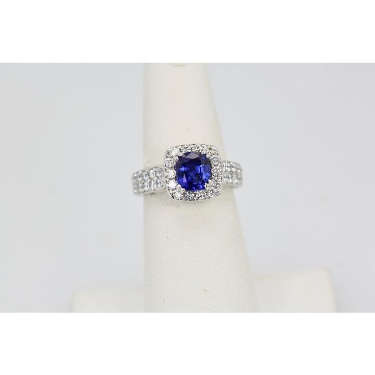 This is part of Chairish’s Fine Jewelry assortment.  Burma Sapphire Ring with Diamond Surround 18k  Everybody loves a nice Blue Sapphire ring. This one is from Burma and the Sapphire is set with a Diamond Surround. It is a gorgeous deep Blue with magnificent sparkle. The color is absolutely wonderful, true Sapphire Blue. The Sapphire has some heating and it weighs 1.25 Carats. There is also 2 Carats of Diamonds in the surround. The Diamonds are G in color and VS2. So, the ring is 3.25 Carats but Sapphire Diamond Ring With Cushion Brilliant Cut, Sapphire Diamond Ring With Cushion Cut, Classic Tanzanite Rings With Brilliant Cut, Formal Tanzanite Fine Jewelry Rings, Tanzanite Brilliant Cut Formal Rings, Luxury Tanzanite Diamond Ring With Round Cut, Luxury Tanzanite Diamond Ring Round Cut, Classic Tanzanite Diamond Ring With Prong Setting, Luxury Round Cut Tanzanite Diamond Ring