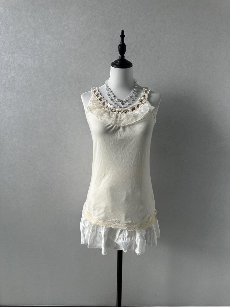 -Preloved, in great condition -Label size M, bust:79-87cm, length:61cm -Best fits uk6-8 dollete coquette balletcore kawaii harajuku dollcore fairy female jfashion grunge Fitted Cream Tank Top With Built-in Bra, Spring Cream Tank Top With Built-in Bra, White Lace Trim Coquettish Top, White Lace Trim Top Feminine Style, Fitted Ruffled Tank Camisole, White Stretch Feminine Tank Top, Stretchy Feminine White Tank Top, Fitted Ruffle Tank Camisole, Coquette Tops With Lace Trim And Spaghetti Straps