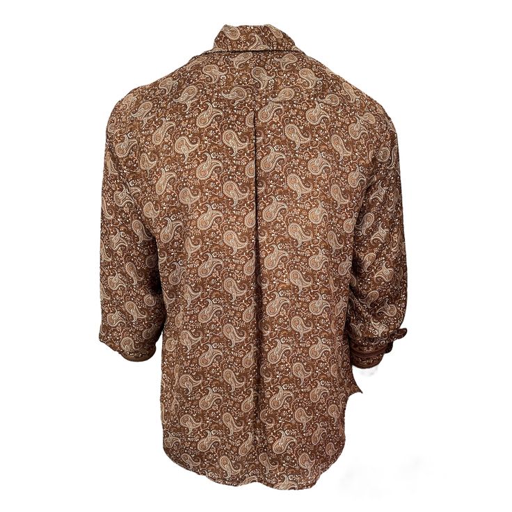 For Kings and Queens. Our Paisley Crepe bronze long-sleeve shirt, crafted from luxurious silk, is both elegant and flowy. The rich brown hue and intricate paisley pattern add sophistication and versatility, while the silky fabric drapes effortlessly and feels soft against the skin. Perfect for both professional and social occasions. 100% Silk   Dry Clean and Hand Wash Luxury Brown Long Sleeve Tops, Gold Silk Blouse For Fall, Brown Long Sleeve Flannel Shirt, Elegant Brown Formal Blouse, Elegant Formal Brown Blouse, Brown Silk Tops For Fall, Long Sleeve Shirt With Paisley Print For Fall, Elegant Brown Long Sleeve Shirt, Elegant Long Sleeve Brown Shirt