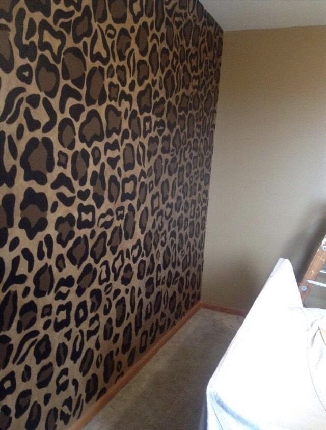 a room with a leopard print wallpaper in the corner