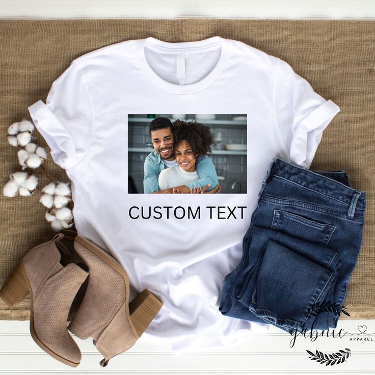 Collaborate with our designers to create your unique and personalized t-shirt. We have over 100s of fonts, graphics, and colors to choose from. You can even send in your own photos! This is a collaborative experience, you will receive mockups along with way for approval. We ask that you have a basic idea of what you want in mind (i.e.- kind of graphics, words, position of text and/or graphics, etc.) but we are willing to collaborate with you along the way to make sure you receive the perfect cus Gift Crew Neck T-shirt With Sublimation Print, Sublimation Print Crew Neck T-shirt For Gift, Crew Neck T-shirt With Sublimation Print As Gift, Customizable Cotton Graphic Tee Shirt, Customizable Cotton Graphic Print T-shirt, Custom Print Crew Neck Top For Gift, Custom Print Crew Neck Top As Gift, Custom Print Cotton T-shirt For Customization, Customizable White Tops As Gifts