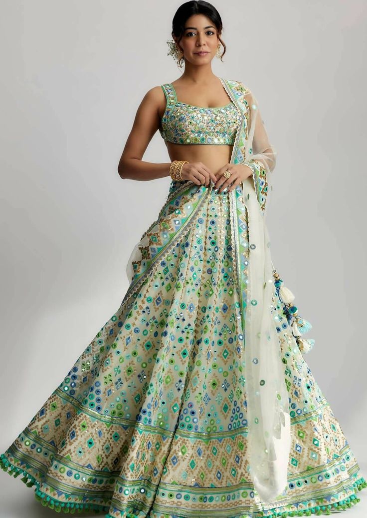 The avantika lehenga set is a stunning ensemble that exudes elegance and grace. Crafted with exquisite attention to detail, this ensemble showcases a beautiful fabric with intricate mirror work and delicate pompoms and tassels. The fabric used in this set is a luxurious blend of high-quality materials, carefully selected to enhance its visual appeal and durability. Winter Lengha, Green Indian Outfit, Bustier Blouse, Indian Fits, Gopi Vaid, Lehenga Design, Tailored Fashion, Desi Outfits, Anarkali Lehenga