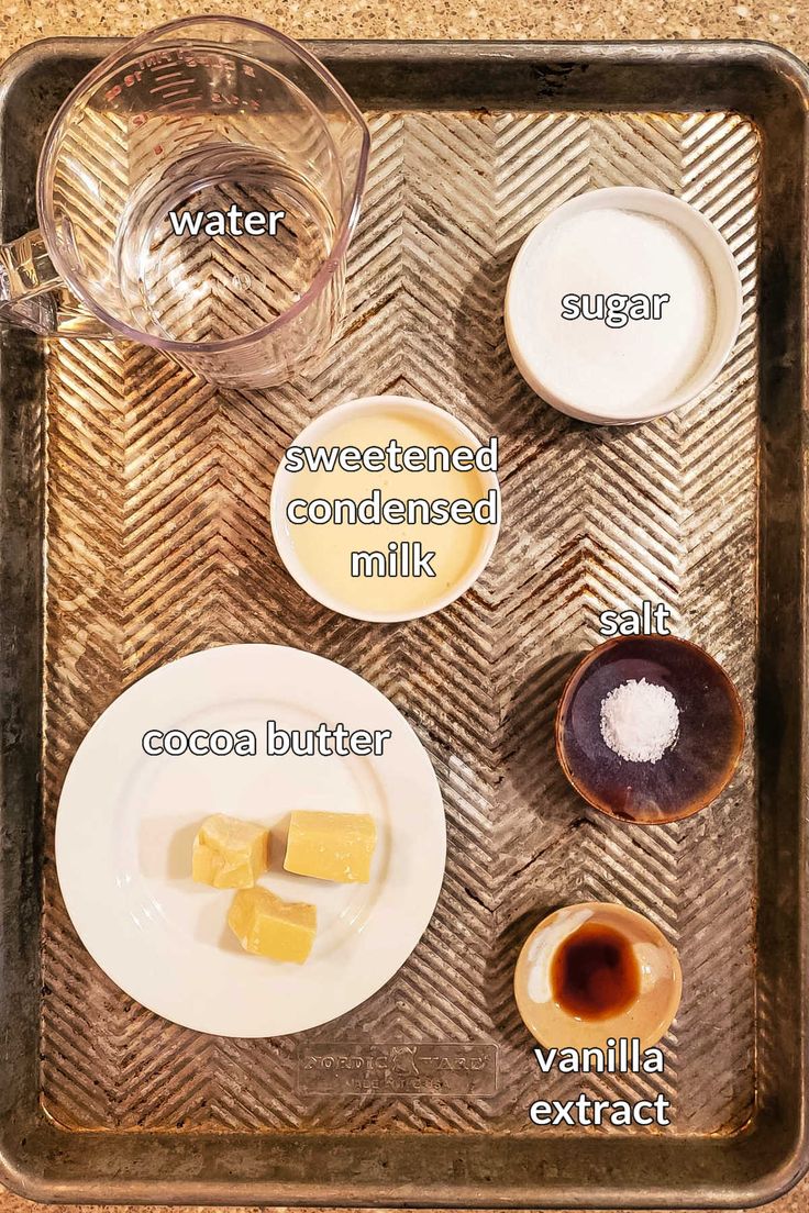 the ingredients for making an ice cream dessert on a tray with water, sugar, and butter