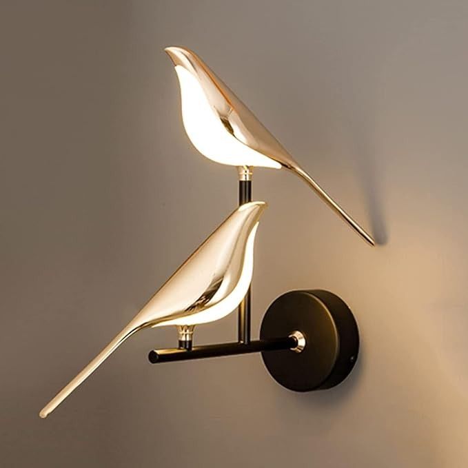 a wall mounted light with a bird on it