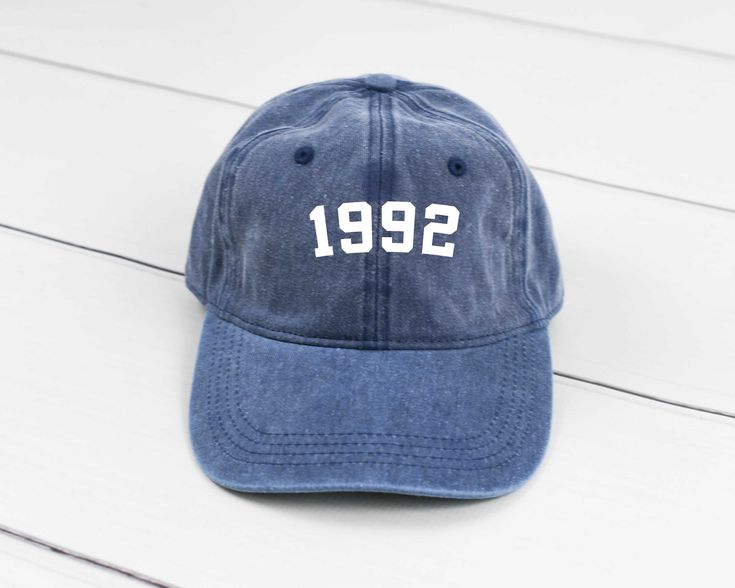 1992 Birth Year - Pigment Dyed Hat Perfect for your birthday celebration! Color Shown In First Picture Is Navy Pigment. Don't See A Color? Message Us! Hat Material: - 100% cotton pigment dyed twill - Unstructured, six-panel, low profile - Self-fabric sweatband and six sewn eyelets - Self-fabric strap with brass snap buckle and sewn grommet - Design is printed on hat with premium vinyl. We Handpick And Choose The Best Quality Brands And Materials! Cool Uncle, Distressed Hat, Mom Hats, Gifts For Uncle, Trendy Hat, Funny Hats, Classic Hats, Birthday Hat, Aunt Gifts