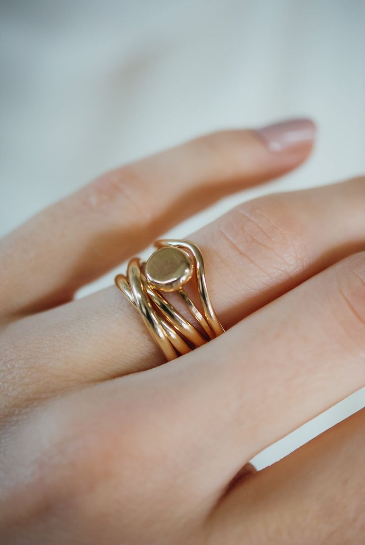 A curved arc stacking ring made from 14K Gold Fill Metal. After countless requests and some fine tuning, we finally perfected this ring shape! The Teardrop Ring stacks with all of our rings beautifully. It adds dimension to any stacking rings you wear daily but it also makes the perfect, low-key wedding band! The bend in the Teardrop Ring curves to hug a set stone beautifully if you are looking for a complimentary piece for your existing engagement ring. This listing is for ONE SINGLE RING.Made Dainty Stackable Rings In Recycled Gold Stamped 14k, Low Key Wedding, Pebble Ring, Ring Stacks, Precious Stones Rings, Teardrop Ring, Single Ring, Stacking Ring Set, Ring Inspo