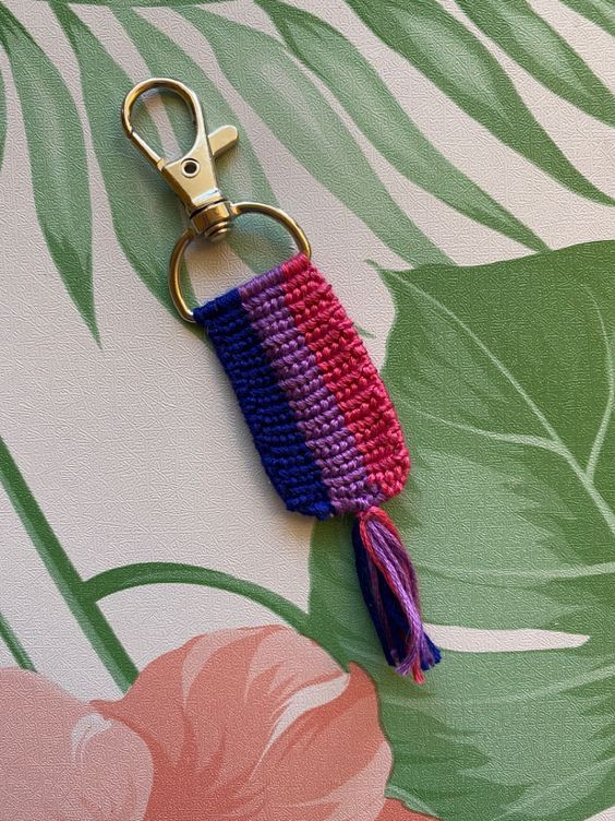 a crocheted keychain with a tassel hanging from it's end