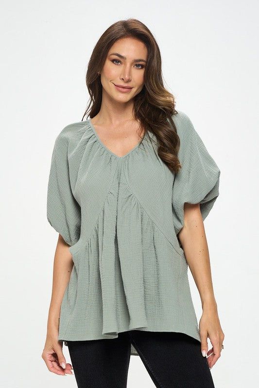 Made in USA Cotton V neck Puff Sleeve Tunic Top. Fabric content: 100% Cotton. Available in other colors. Style: casual, formal Print / Pattern: solids Silhouette: oversized Fit: oversized Neck Line: v neck Sleeve: shortsleeve Lining: no Made In: Made in U.S.AFabric Contents: 100% Cotton.Size Measurement (inch): S: 18.5 (Bust), 21.0 (Waist), 27.0 (Hips), 28.0 (Length) M: 19.5 (Bust), 22.0 (Waist), 28.0 (Hips), 28.5 (Length) L: 20.5 (Bust), 23.0 (Waist), 29.0 (Hips), 29.0 (Length) Casual Puff Sleeve Top In Solid Color For Spring, Casual Solid Color Puff Sleeve Top For Spring, Versatile Spring Blouse In Solid Color, Versatile Blouse For Spring, Chic Relaxed Fit Solid Color Blouse, Chic Relaxed Fit Solid Color Top, Spring Oversized Blouse In Solid Color, Solid Color Billowy Lantern Sleeve Tops, Billowy Lantern Sleeve Solid Tops