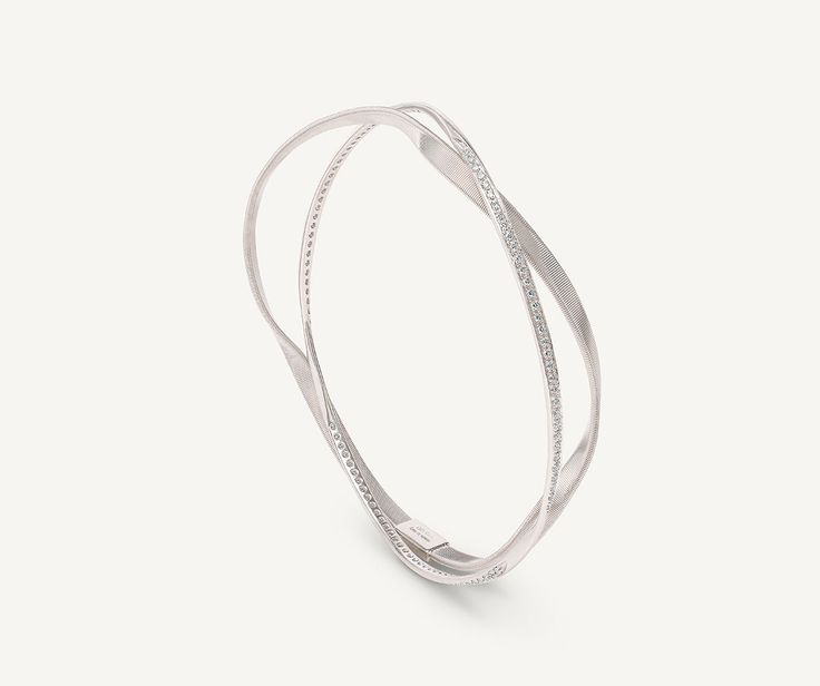 An 18K white gold twisted thread, carefully crafted with our exclusive coil technique, intertwines with a white gold thread embellished with brilliant-cut diamonds. With its sophisticated design, this bangle bracelet can be worn alone or stacked with more bangles for a mix and match effect. Luxury Flexible Silver Bangle, White Gold Spiral Jewelry For Formal Occasions, Modern White Gold Spiral Jewelry, Formal Spiral White Gold Jewelry, Formal White Gold Spiral Jewelry, Modern Spiral White Gold Jewelry, Modern Twist White Gold Jewelry With Diamond Accents, Modern White Gold Jewelry With Diamond Accents, Elegant Spiral Bracelets For Formal Occasions