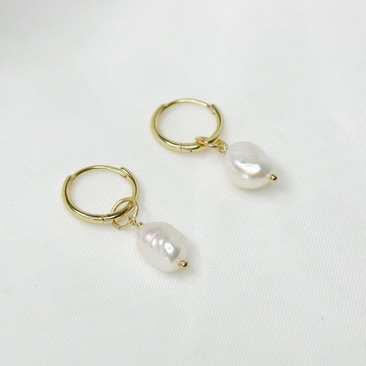 Inspired by the beautiful waters of Venice, the gorgeous Venice huggies feature a brilliant real freshwater pearl charm. They are 925 Sterling Plated Plated and super comfy to sleep in so you never have to take them off, making them the perfect everyday piece. Pair them with our Sydney huggies for a bolder look. ♡ Handcrafted ♡ 14k Gold Plated Plated on Sterling Silver  ♡ Water Resistant ♡ Natural Freshwater Pearl ♡ Hypoallergenic  ♡ Available in both 10mm and 13mm Huggies Please note all our pe Classic Huggie Jewelry With Pearl Charm, Delicate Huggie Pearl Earrings With Charm, Hypoallergenic Yellow Gold Huggie Pearl Earrings, Dainty Huggie Jewelry With Pearl Drop, Dainty Hypoallergenic White Gold Pearl Earrings, Pearl Pendant Dangle Hoop Earrings Gift, Dangle Hoop Earrings With Pearl Pendant Gift, Gift Dangle Hoop Earrings With Pearl Pendant, Gift Hoop Earrings With Pearl Pendant And Dangle