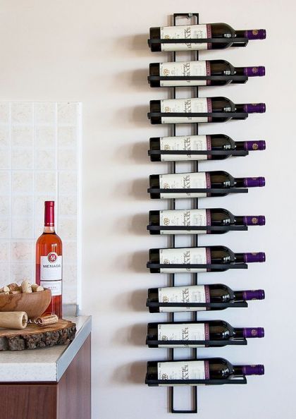 a wall mounted wine rack with bottles on it