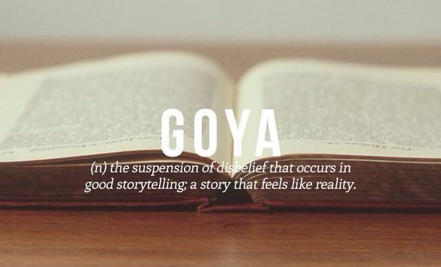 an open book sitting on top of a wooden table with the words goya above it