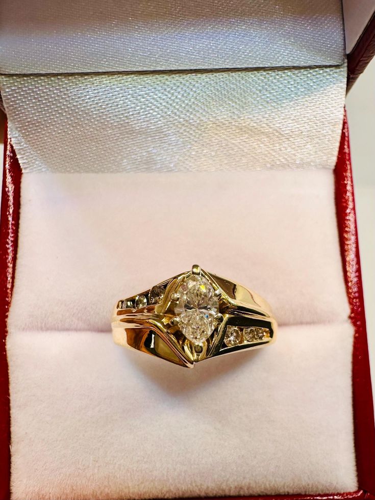 a yellow gold ring in a red velvet box