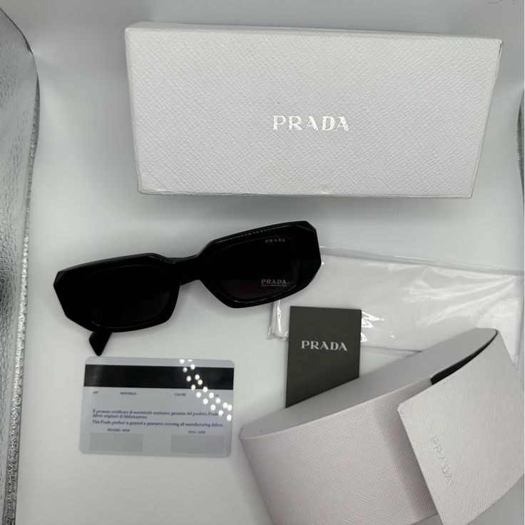 Prada Color - Black High Quality, Inventiveness, And A Solid Legacy Of Workmanship Are Hallmarks Of This World-Renowned Fashion Leader's Signature Style. The Subtle Aesthetic Of Prada Has Always Foreshadowed And Frequently Set Trends In Fashion. Prada Sunglasses Combine The Best Materials Available To Create The Perfect Harmony Between Style And Functionality. These Sunglasses Are Ideal For Ladies Who Like To Give Their Ensemble A Hint Of Refinement. For Every Event, Including A Night Out With F Prada Products Aesthetic, Prada Sunglasses Aesthetic, Prada Shades, Prada Pr 17ws, Luxury Sunglasses Women, Subtle Aesthetic, Prada Sunnies, Prada Aesthetic, Branded Sunglasses