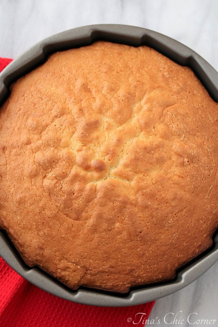 a cake in a pan sitting on top of a red towel