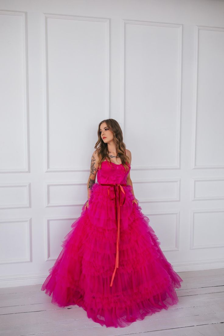 This hot pink princess dress will make you feel like you stepped straight out of a fairy tale. With its floor length and voluminous design,  it's perfect for any romantic occasion, from weddings to proms.  The small velvet belt and bow ties add unique and beautiful touches,  making you look and feel majestic.  (No awkward pumpkin coach rides here.) Message me for any kind of customizations. Pink Floor-length Wedding Dress For Prom Season, Pink Princess Tulle Evening Dress, Pink Ball Gown Evening Dress For Wedding, Fitted Pink Quinceanera Dress For Party, Pink Princess Style Evening Dress For Wedding, Pink Tulle Wedding Dress For Prom Season, Pink Floor-length Ball Gown For Prom Season, Pink Floor-length Wedding Dress For Party, Pink Princess Evening Dress