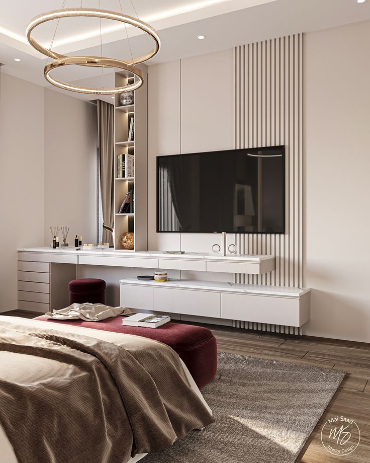 a bedroom with a bed, television and large mirror on the wall above it's headboard