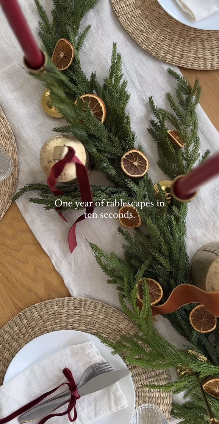 the table is set with place settings for two people to enjoy their meal, and there are pine cones on the napkins