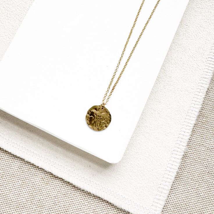 Dainty, elegant, and versatile. The Ross Necklace will become your "go-to" for everyday wear and layering. - adjustable, 18 to 20 inches in length- 1/2 inch textured circle, on rolo chain - matches our "Rachel" Earrings - available in 14K Gold filled or Sterling Silver (Find out more about our metals HERE!) Adjustable Round Medallion Necklace As Gift, Everyday Coin Necklace With Delicate Chain, Everyday Delicate Chain Coin Necklace, Everyday Hammered Round Disc Coin Necklace, Elegant Coin Pendant Medallion Necklace, Elegant Adjustable Medallion Necklace With Coin Pendant, Medallion Coin Necklace With Cable Chain As Gift, Adjustable Necklace With Coin Pendant, Elegant Adjustable Coin Pendant Medallion Necklace