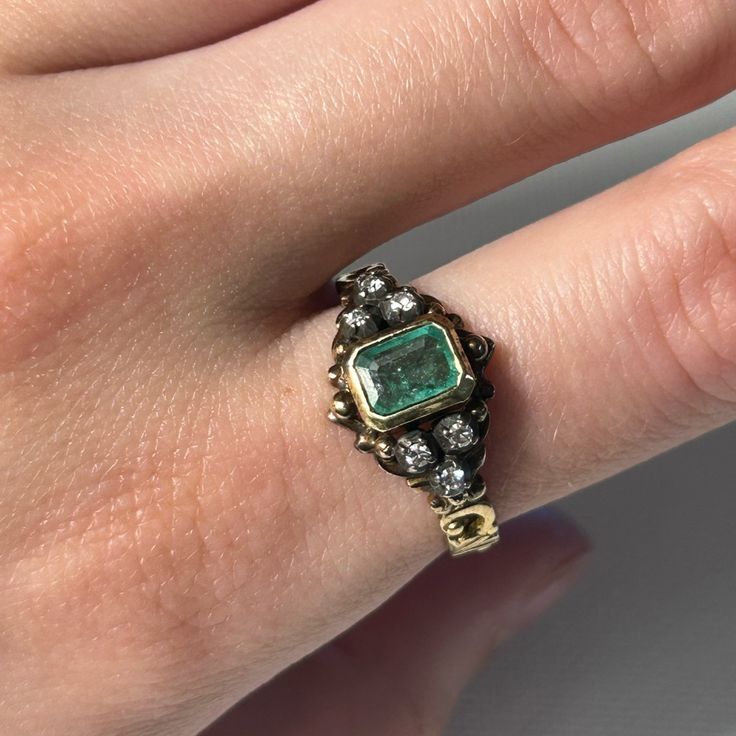 Beautiful Open Worked Scrolling Details Adorn This Lovely Victorian Style Ring. A Bezel Set Emerald Is Placed At The Center Of The Ring And Is Clearly The Main Attraction. 3 Small Single Cut Diamonds Flank The Emerald On Each Side And Work To Add Intrigue To The Ring. Currently Size 7 1/2 Diamond Color I - J Emerald Weight Estimated .5ct Emerald Dimensions 6.25l X 4.6w X 2.6d Heirloom Emerald-cut Ring With Single Cut Diamonds, Heirloom Emerald Cut Ring With Single Cut Diamonds, Oval Emerald Ring With Single Cut Diamonds, Green 14k Gold Jewelry With Single Cut Diamonds, Heirloom Bezel Setting May Birthstone Jewelry, Heirloom Jewelry With Bezel Setting For May Birthstone, Victorian Emerald Ring In Yellow Gold Stamped 14k, Antique Emerald Ring In Stamped 14k Yellow Gold, Victorian Emerald Ring In 14k Yellow Gold