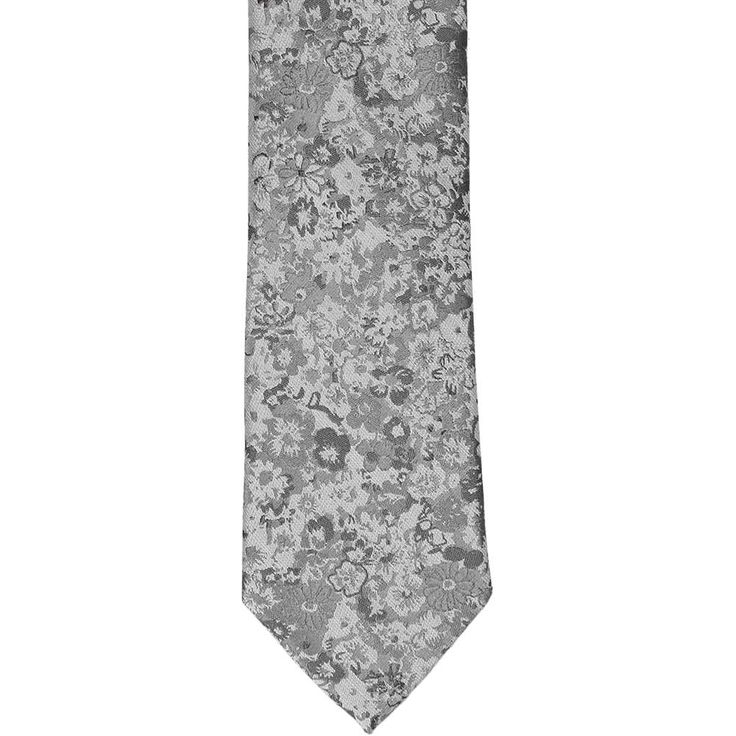 Florals are trending, and this gray floral silk necktie is the one to own! You'll find that it pairs perfectly with suits for your wedding day or office attire thanks to the various, neutral shades of gray. (Take your pick of a navy blue, gray, black or even a burgundy suit.) It's really an all-occasion tie that will stay in style for years to come. If you're considering it for your wedding, don't forget to purchase the matching pocket squares for your groomsmen's jackets! More colors are availa Elegant Floral Print Accessories For Black Tie, Gray Standard Tie For Formal Occasions, Gray Wedding Tie, Gray Suit And Tie Accessories For Black Tie Event, Burgundy Suit, Designer Ties, Neutral Shades, Shades Of Gray, Office Attire