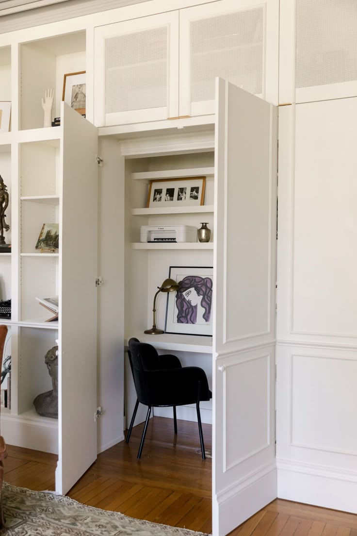 an open bookcase in the corner of a room