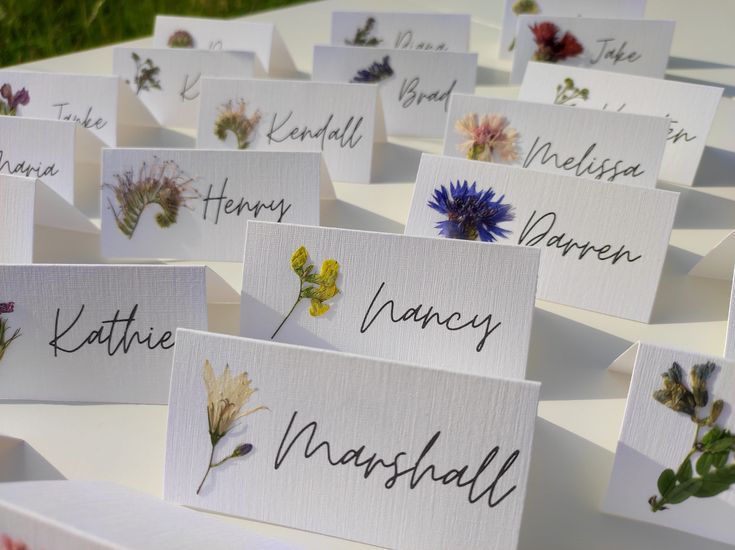 many cards with flowers and names on them