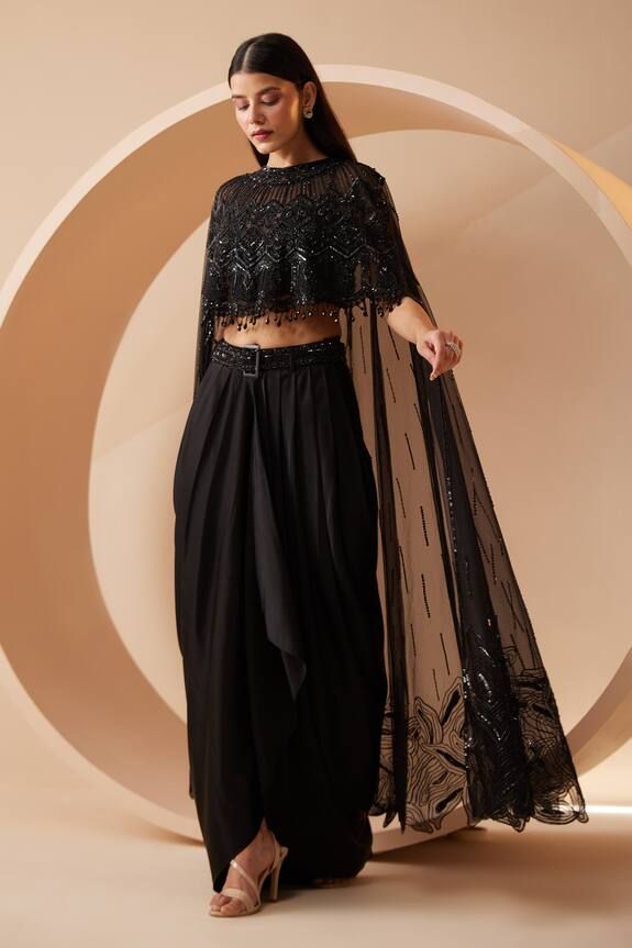 Black asymmetric drape attached cape with all over tonal sequin work. Paired with a dhoti pant and sequin work belt. Components: 3 Pattern: Embroidery Type Of Work: Sequins, Cutdana Neckline: Round Neck Sleeve Type: Drape Sleeves Fabric: Cape: Net, Dhoti Pant: Modal Satin Color: Black Other Details:  Crystal lace on cape Occasion: Cocktail - Aza Fashions Black Dhoti, Cape Set, White Lehenga, Draped Saree, Women Kurta, Crystal Lace, Work Belt, Pant Women, Dress Book