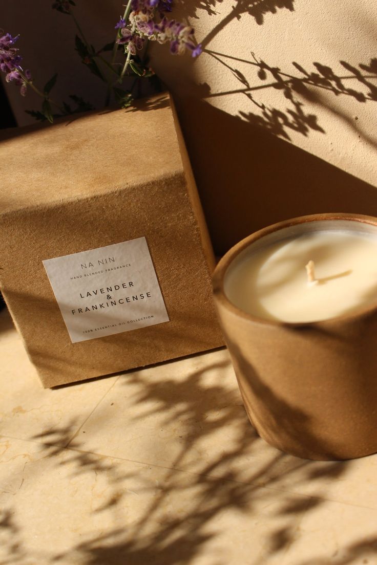 a candle sitting next to a brown paper bag