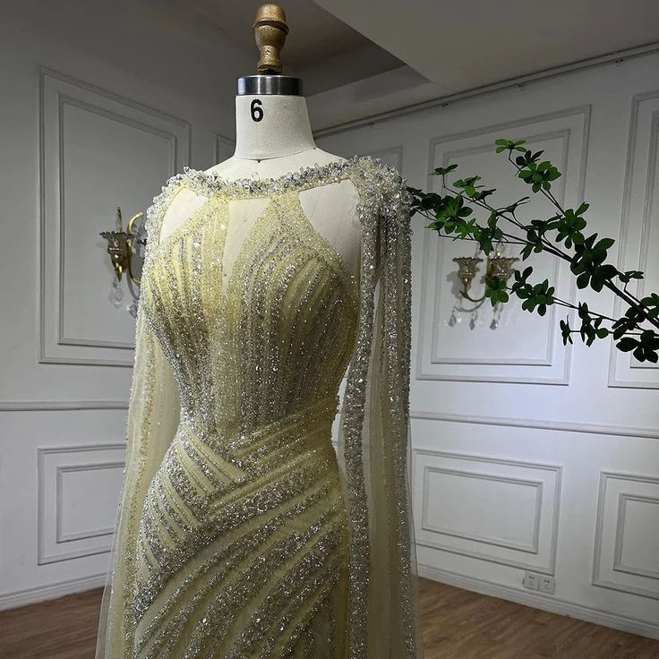 Dubai-Inspired Elegance: Our gown is inspired by the rich tradition of Dubai's fashion, featuring intricate designs and exquisite crystal embellishments that exude luxury and cultural richness. Striking Yellow Hue: The striking yellow hue adds a touch of vibrancy and sophistication to your ensemble, making it an ideal choice for weddings and formal gatherings. Flattering Fit: Our dresses are tailored to provide a flattering fit that enhances your natural beauty and ensures comfort throughout the Luxury Rhinestone Wedding Gown, Floor-length Rhinestone Gown For Banquets, Floor-length Rhinestone Gown For Banquet, Sparkling Floor-length Gown For Pageants, Sparkling Floor-length Gown For Pageant, Floor-length Rhinestone Evening Dress For Pageant, Floor-length Evening Dress With Rhinestones For Pageant, Floor-length Evening Dress With Rhinestones For Pageants, Elegant Floor-length Pageant Dress For Wedding