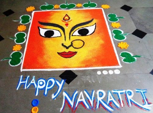 happy navritri written on the ground in front of an image of a face