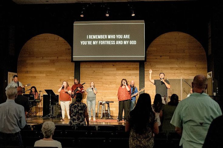 a group of people standing on top of a stage