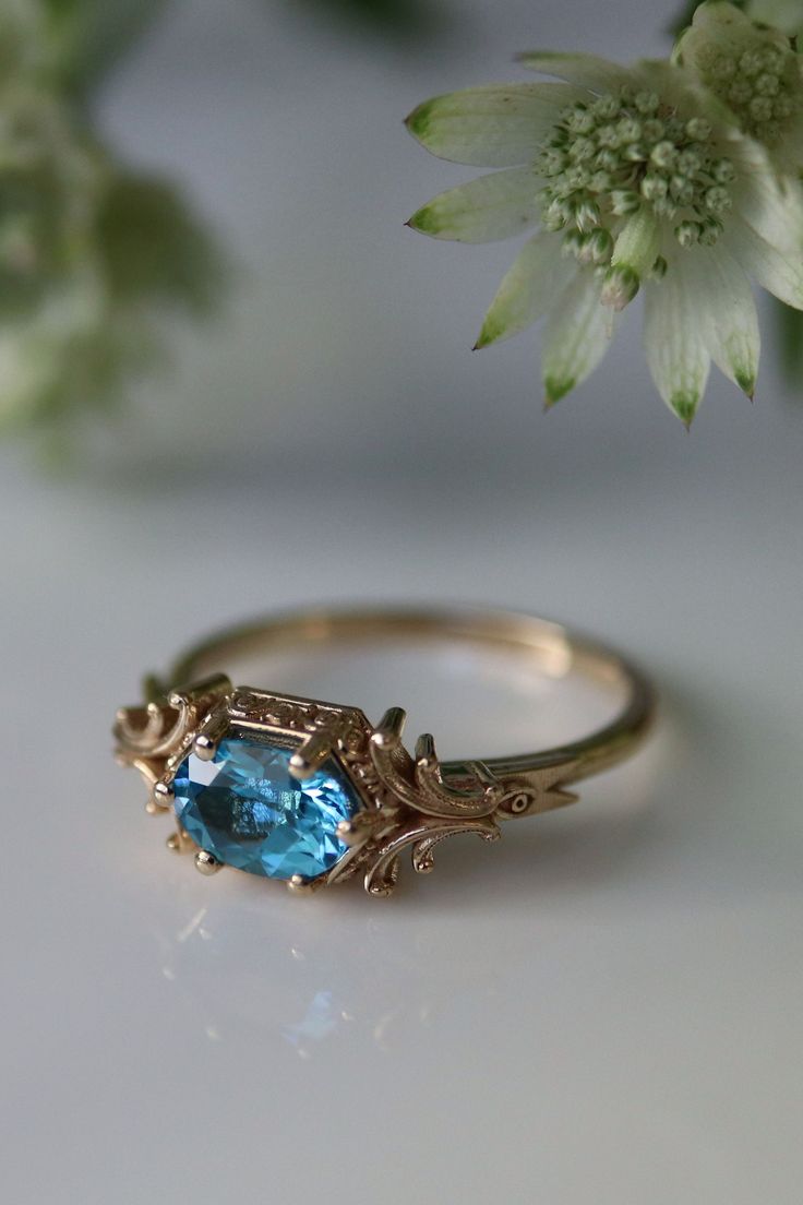 Inspired by Mages from online role-playing games like World of Warcraft, this magical ring is covered in ornate golden scrolls - available in recycled 14 karat yellow, white, and rose gold Heirloom Topaz Rings For Gift, Heirloom Style Blue Topaz Ring With Sapphire Color, Heirloom Blue Topaz Sapphire Ring, Heirloom Blue Topaz Ring With Sapphire Color, Heirloom Blue Topaz Ring With Center Stone, Heirloom Sapphire Blue Topaz Ring, Victorian Yellow Gold Jewelry With Accent Stones, Antique Jewelry With Gemstone Accents For Wedding, Antique Gemstone Accent Jewelry For Weddings