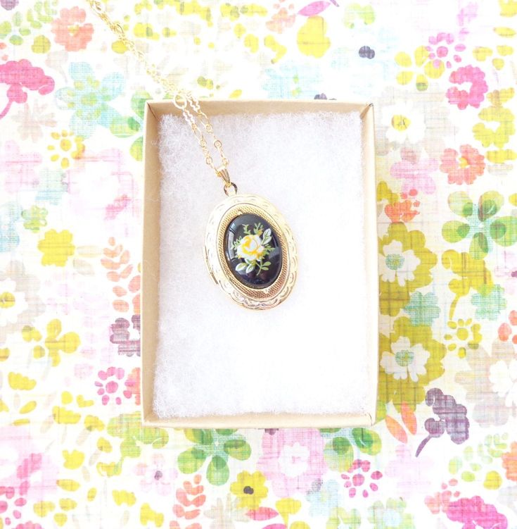 "A gorgeous gold plated photo locket adorned with a lovely vintage black glass limoges with yellow rose dangles so pretty from a 16k gold plated link chain with lobster clasp. Locket has a lovely etched pattern Total length of chain measures 18\" Locket measures 23x30mm Cameo measures 18x13mm Locket is high quality and nickel free Matching bracelet available in my shop as shown in photo 4 (sold out) Your purchase will come beautifully wrapped ready for gift giving" Vintage Gold Jewelry With Birth Flower, Vintage Pressed Flowers Keepsake Jewelry, Vintage Pressed Flowers Jewelry Keepsake, Vintage Gold Jewelry With Birth Flower Detail, Vintage Gold Necklace With Pressed Flowers, Gold Cameo Necklace For Keepsake, Vintage Birth Flower Medallion Jewelry, Vintage Medallion Jewelry With Birth Flower, Vintage Birth Flower Pendant Jewelry